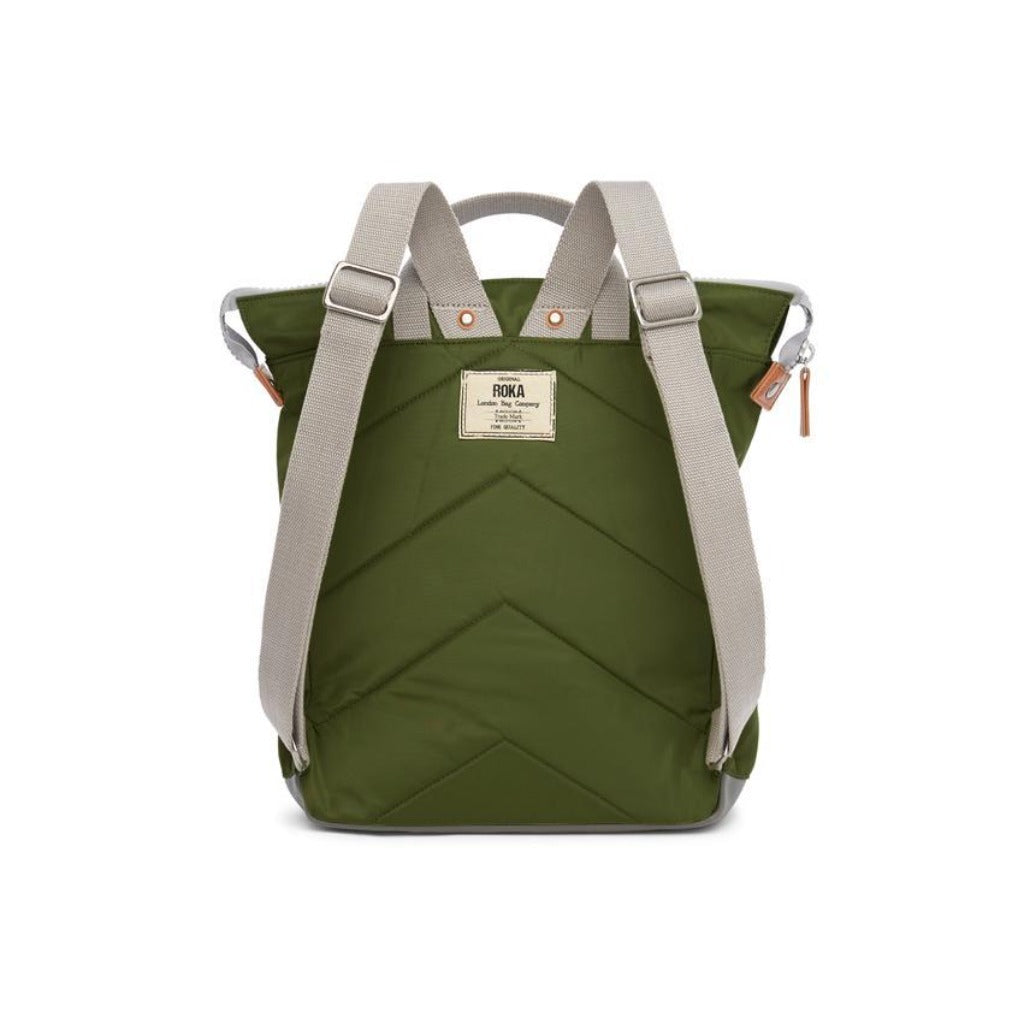Olive green quilted backpack with light gray straps and a small brand label.