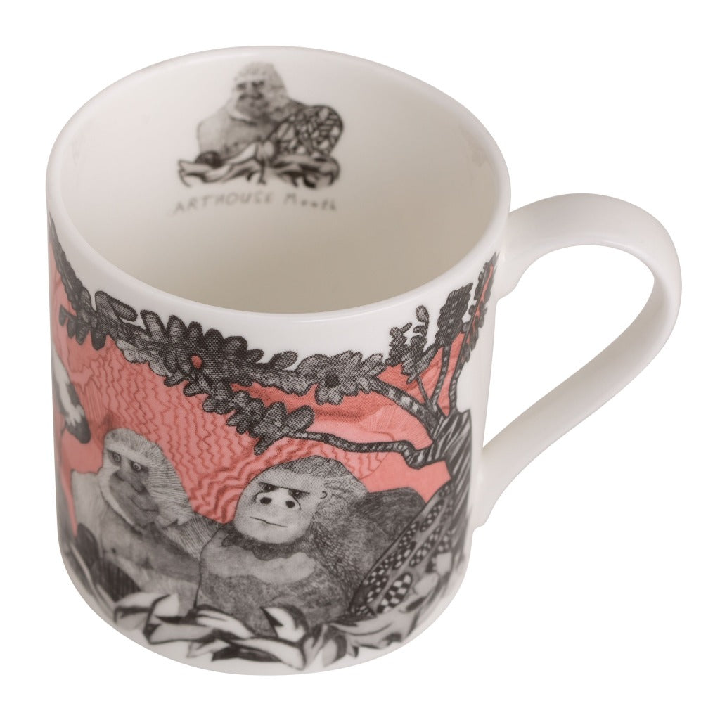 White mug with a coral and gray illustration of gorillas and foliage. The ArtHouse logo is visible inside the mug.