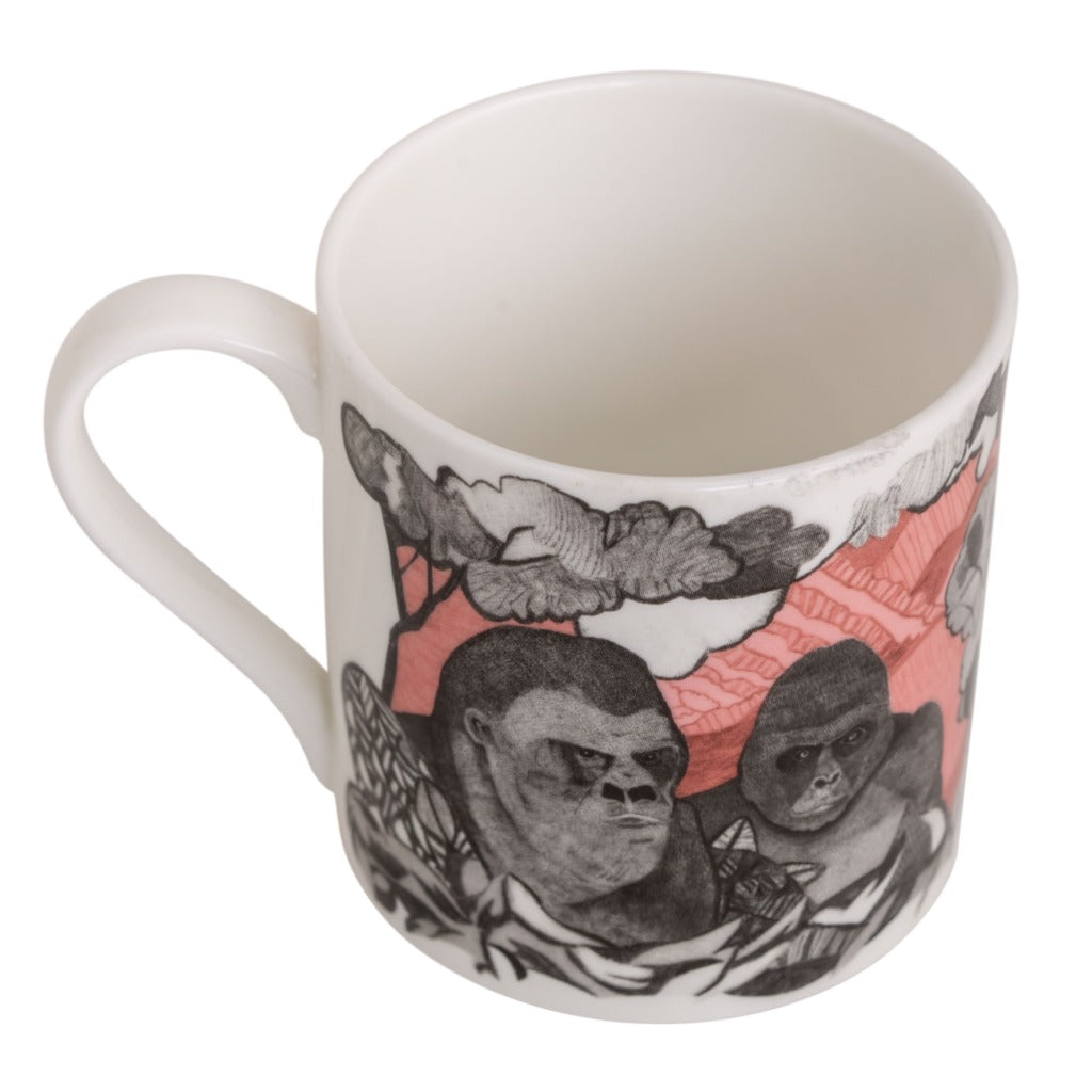 White mug featuring a grayscale illustration of two gorillas amidst a stylized landscape with pink accents.