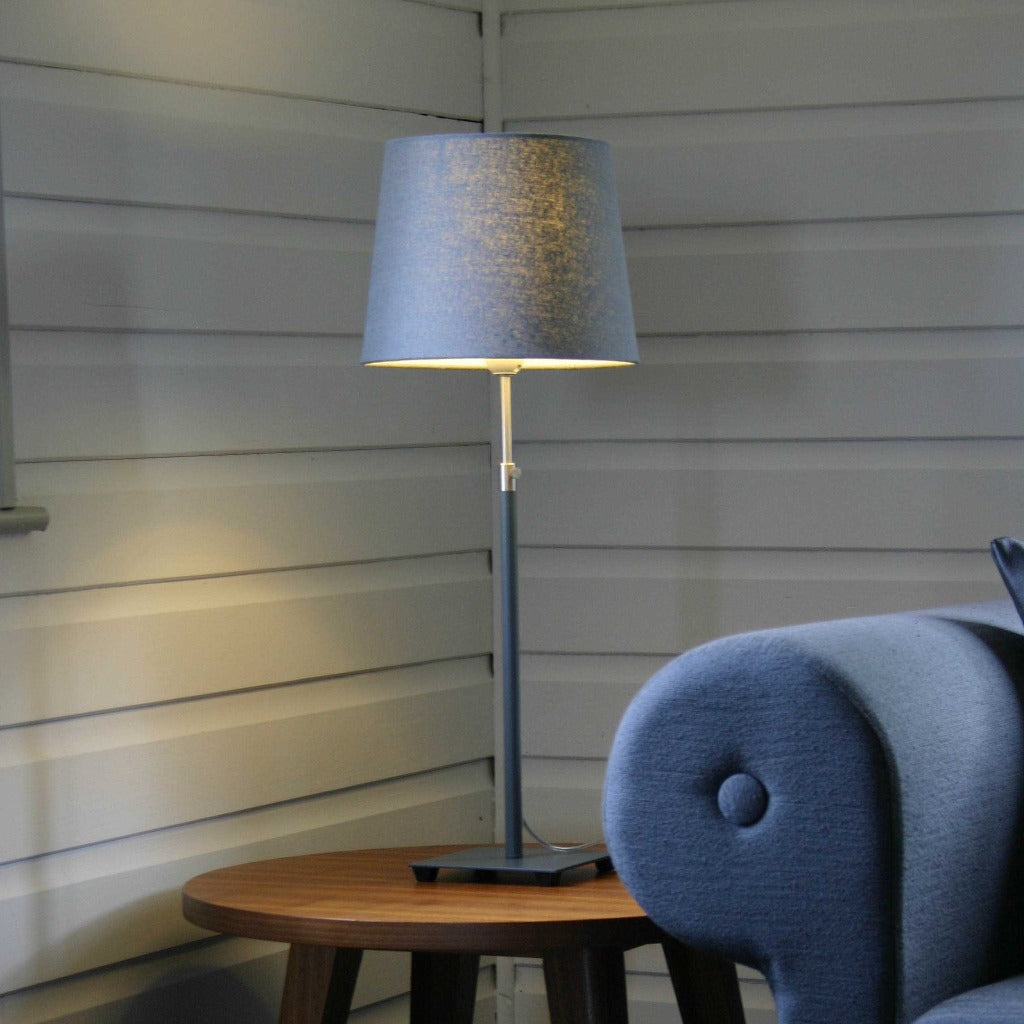 Modern table lamp with a gray fabric shade and a dark gray metal base.