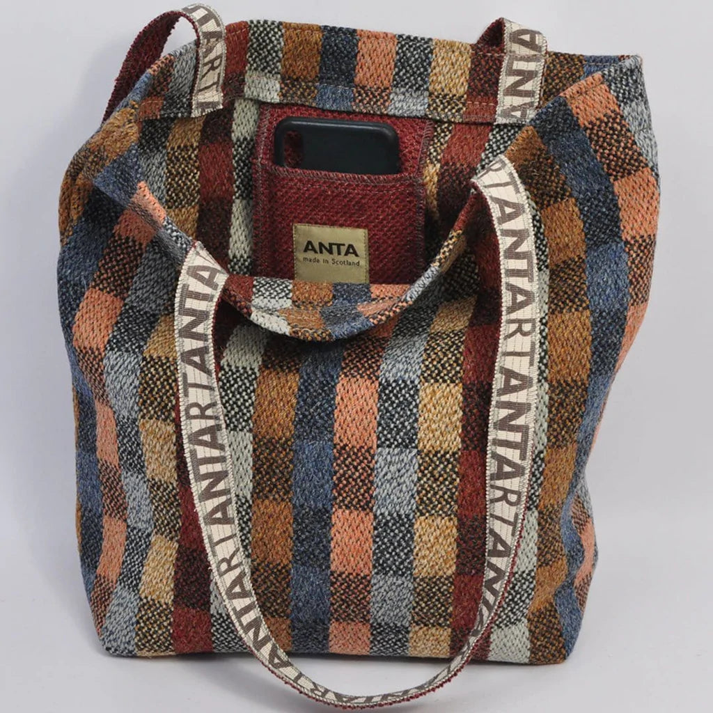 Multicolored plaid tote bag with "TARTAN ANTA" woven into the straps.  Features an interior pocket.