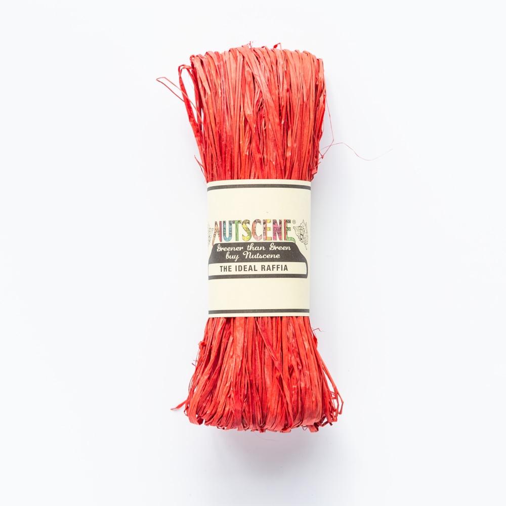 A roll of bright red raffia, labeled "Nutscene The Ideal Raffia".