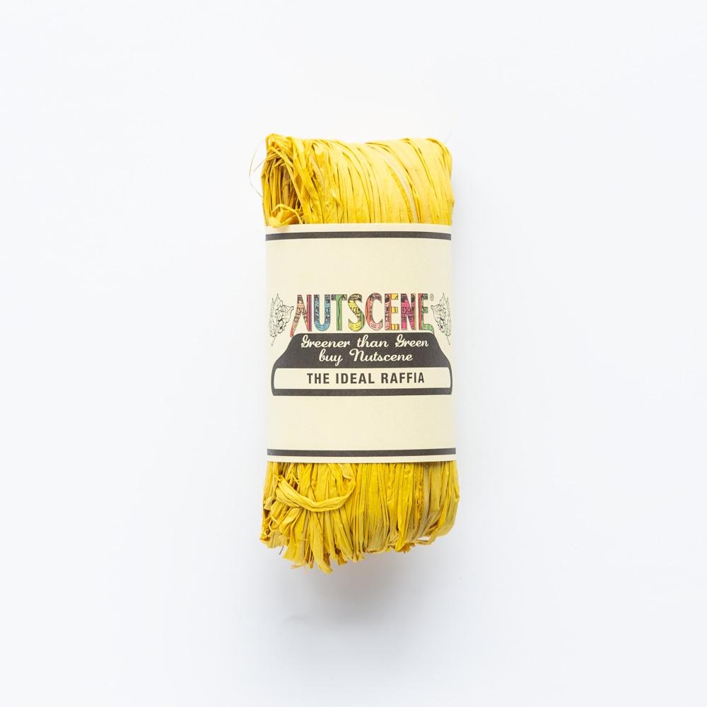 A roll of bright yellow raffia, labeled "NUTSCENE The Ideal Raffia,"  with the tagline "Greener than Green buy Nutsene."