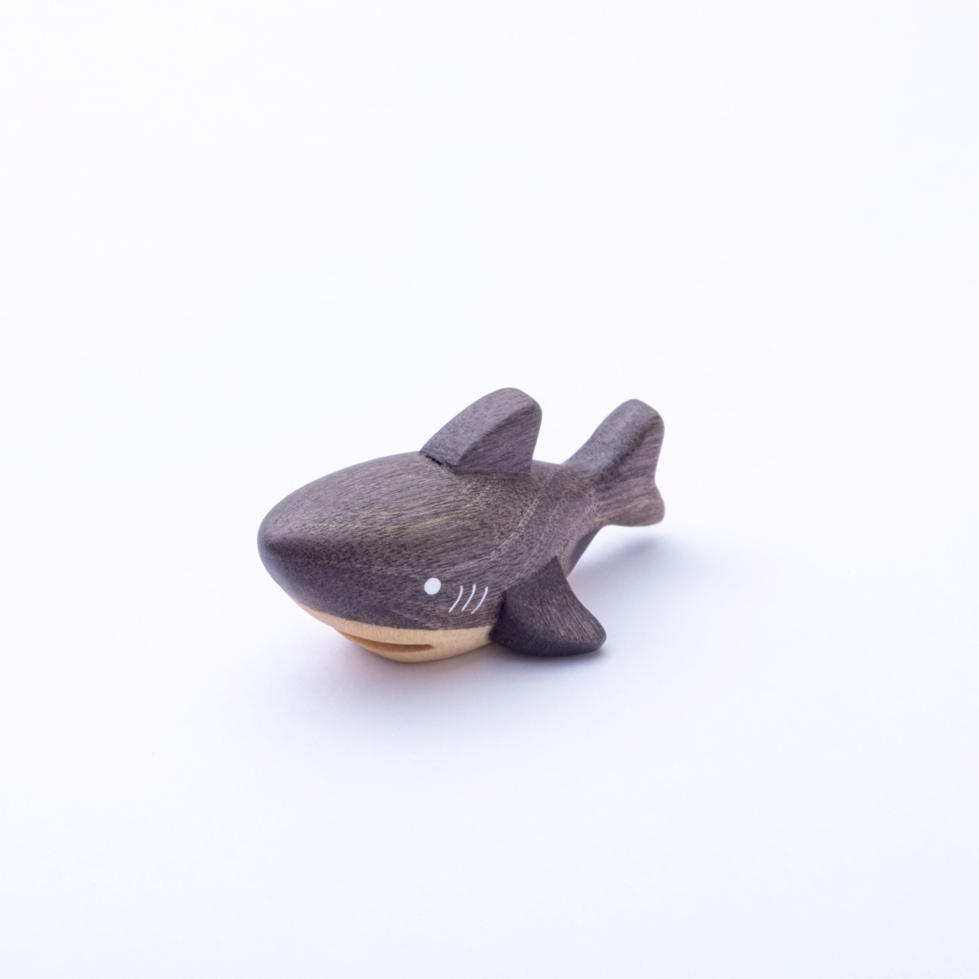 Wooden shark toy on a white background