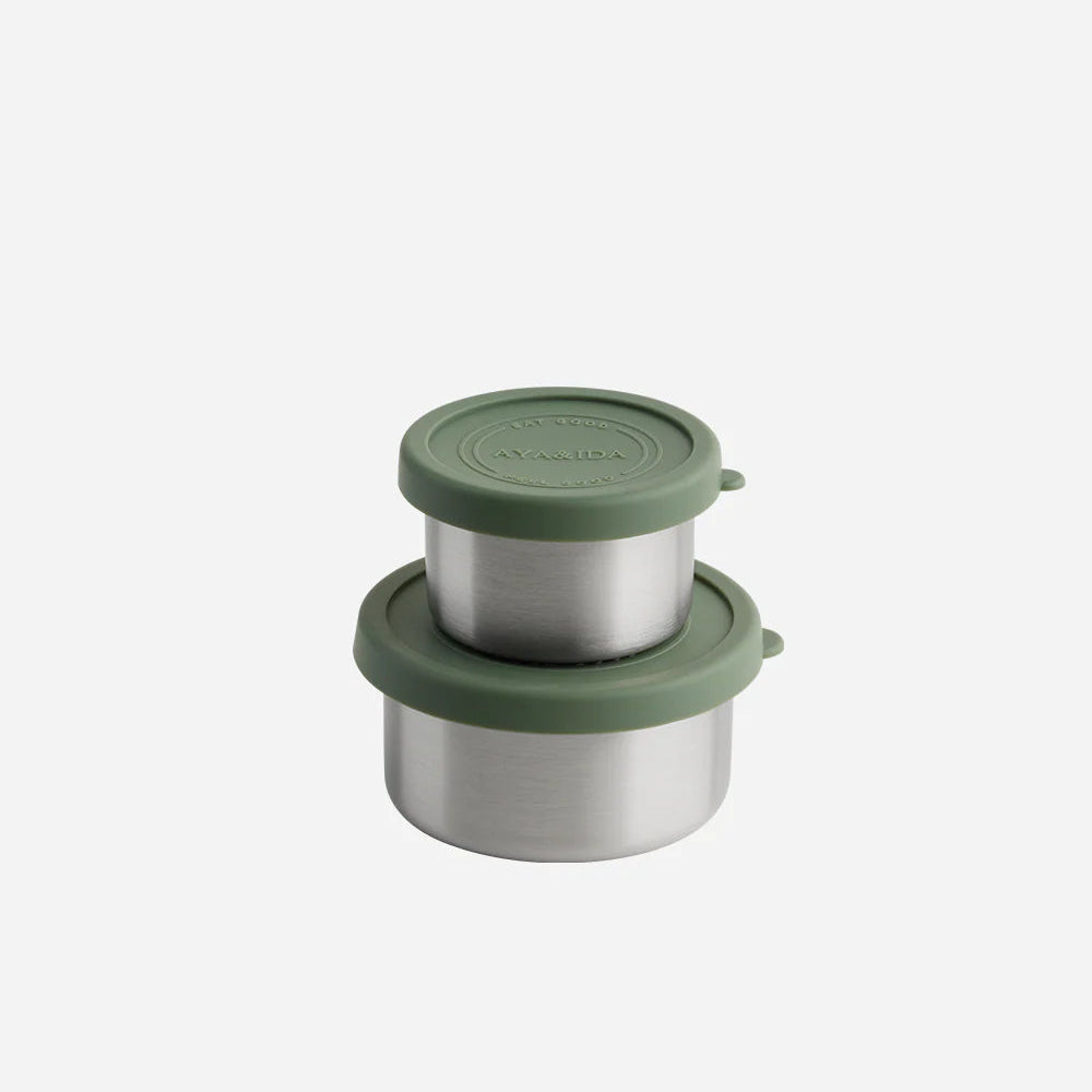 Set of stainless steel containers with green lids on a white background