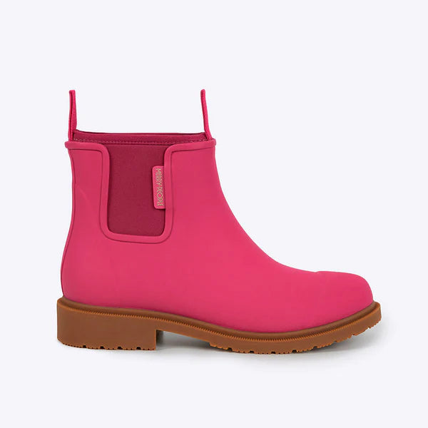 Pink rain boot with brown sole on a white background