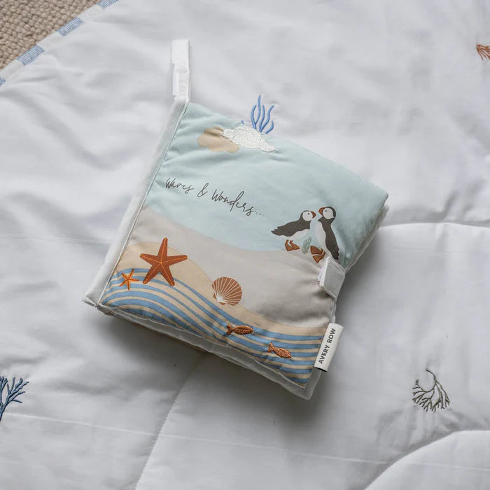 Folded fabric with ocean-themed design on a textured surface