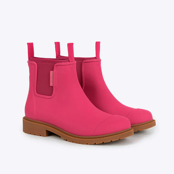 Pair of pink rain boots with brown soles on a white background