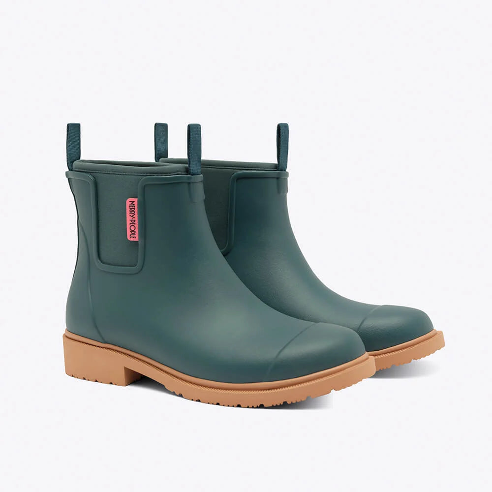 Pair of green rain boots with brown soles on a white background
