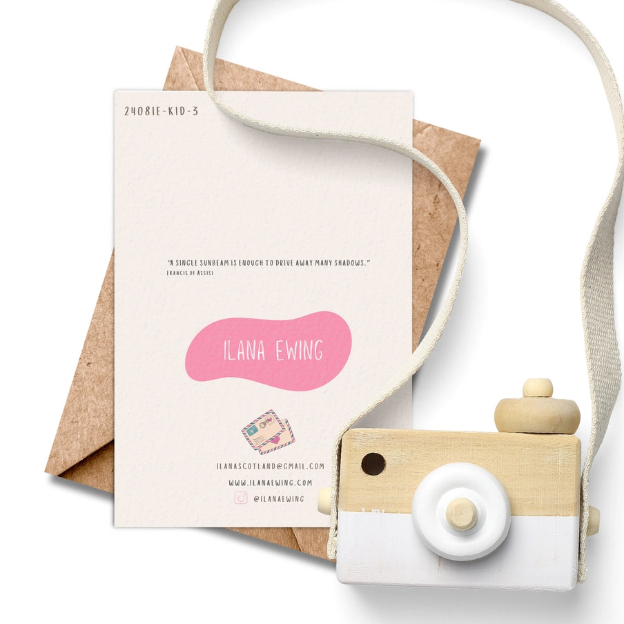 Cream-colored greeting card with pink artist logo, contact info, and quote by Francis of Assisi.