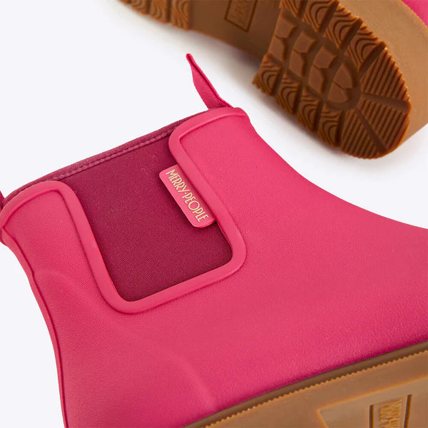 Close-up of a pink boot with a brown sole on a white background