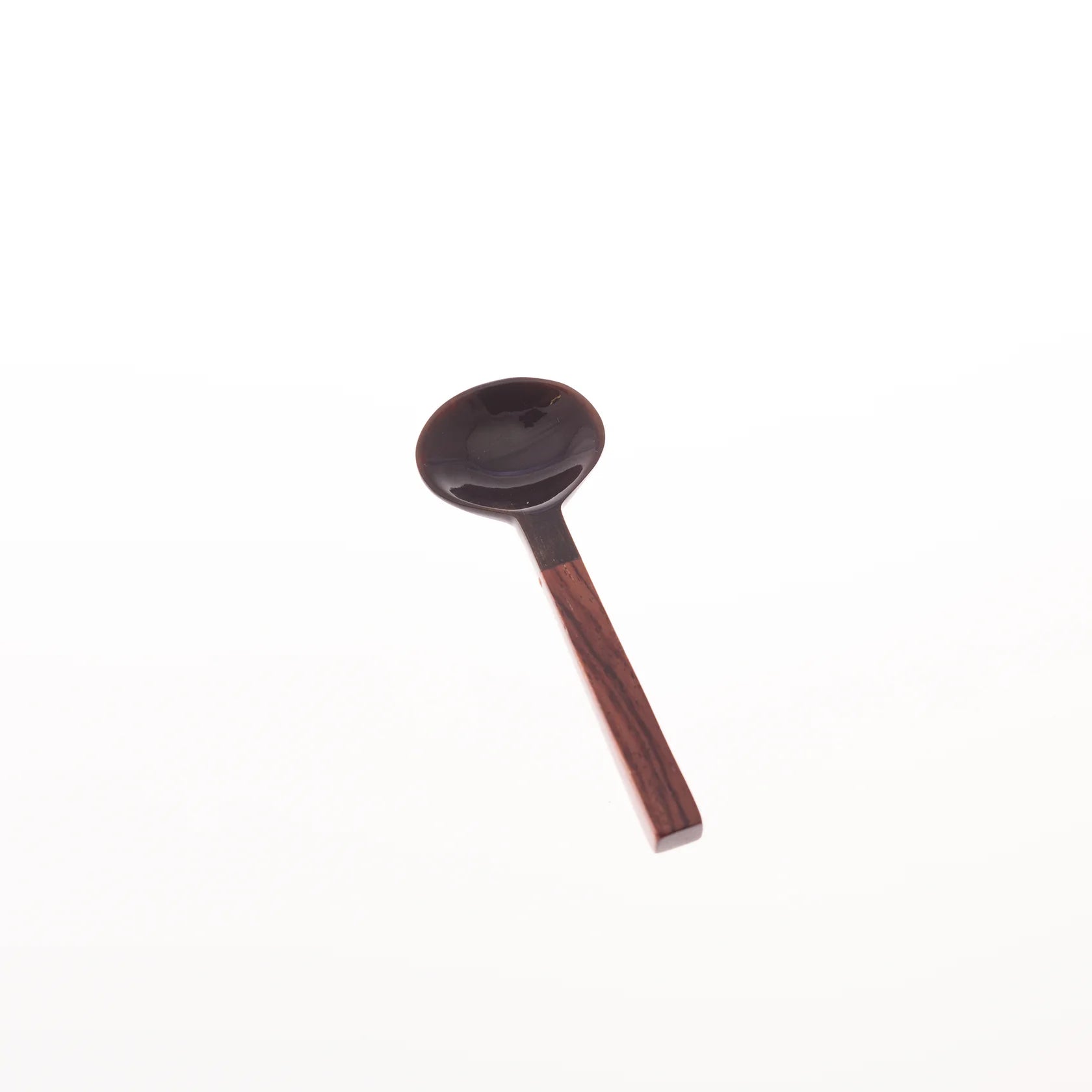 Dark brown ceramic spoon with a dark wood handle.