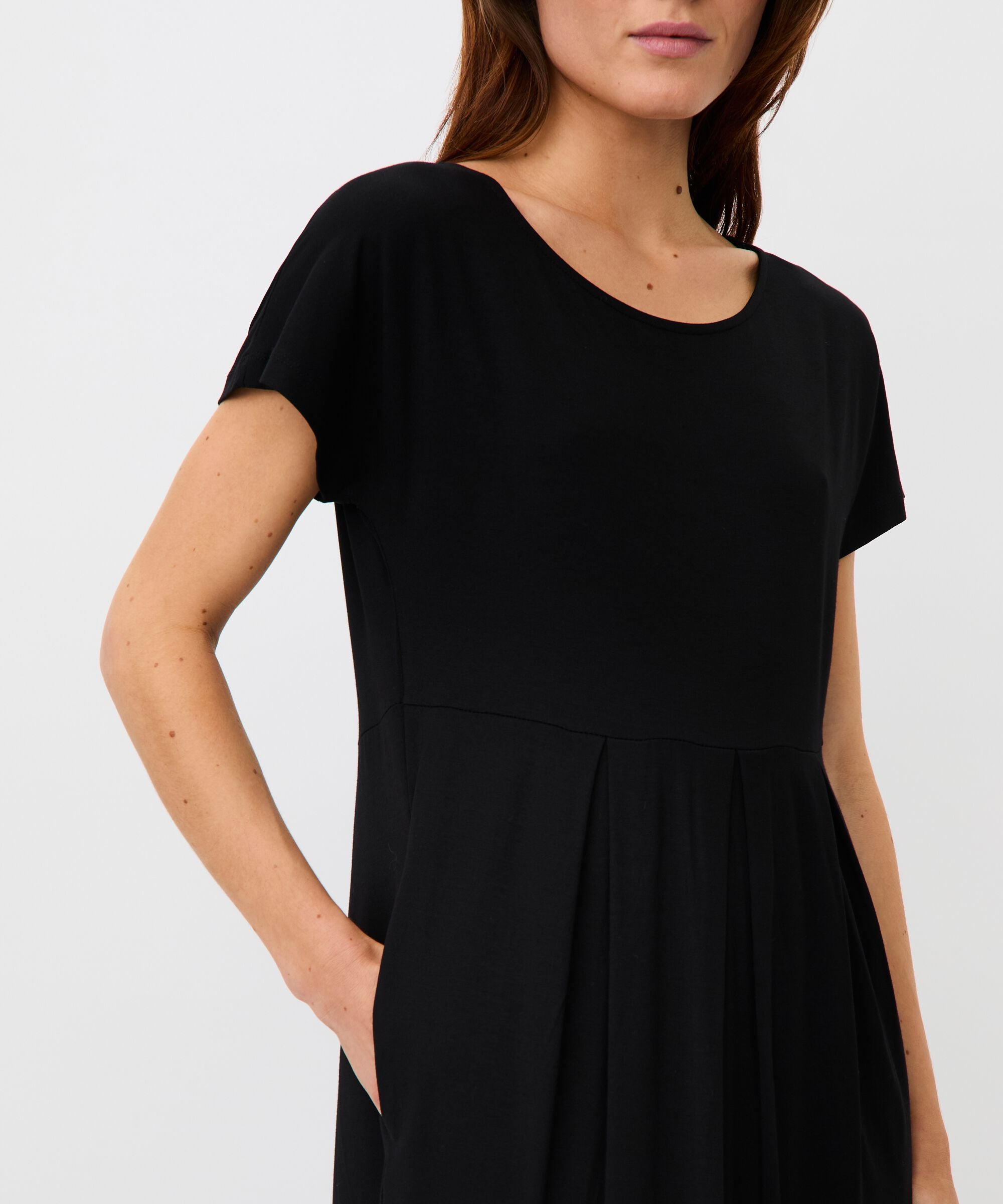 Black dress worn by a person on a white background