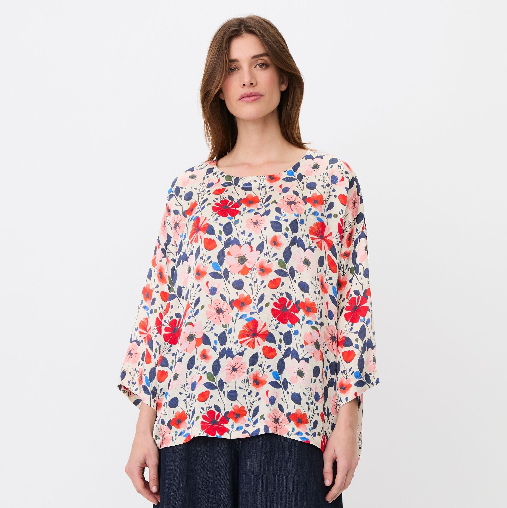 Woman wearing a floral blouse with a white background
