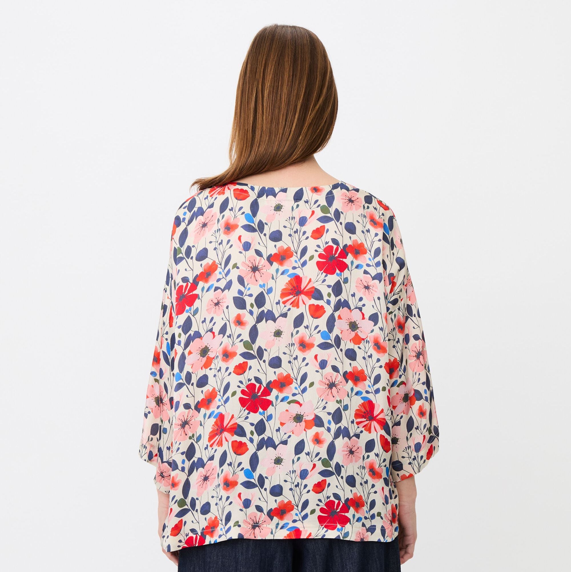 Woman wearing a floral blouse with a white background