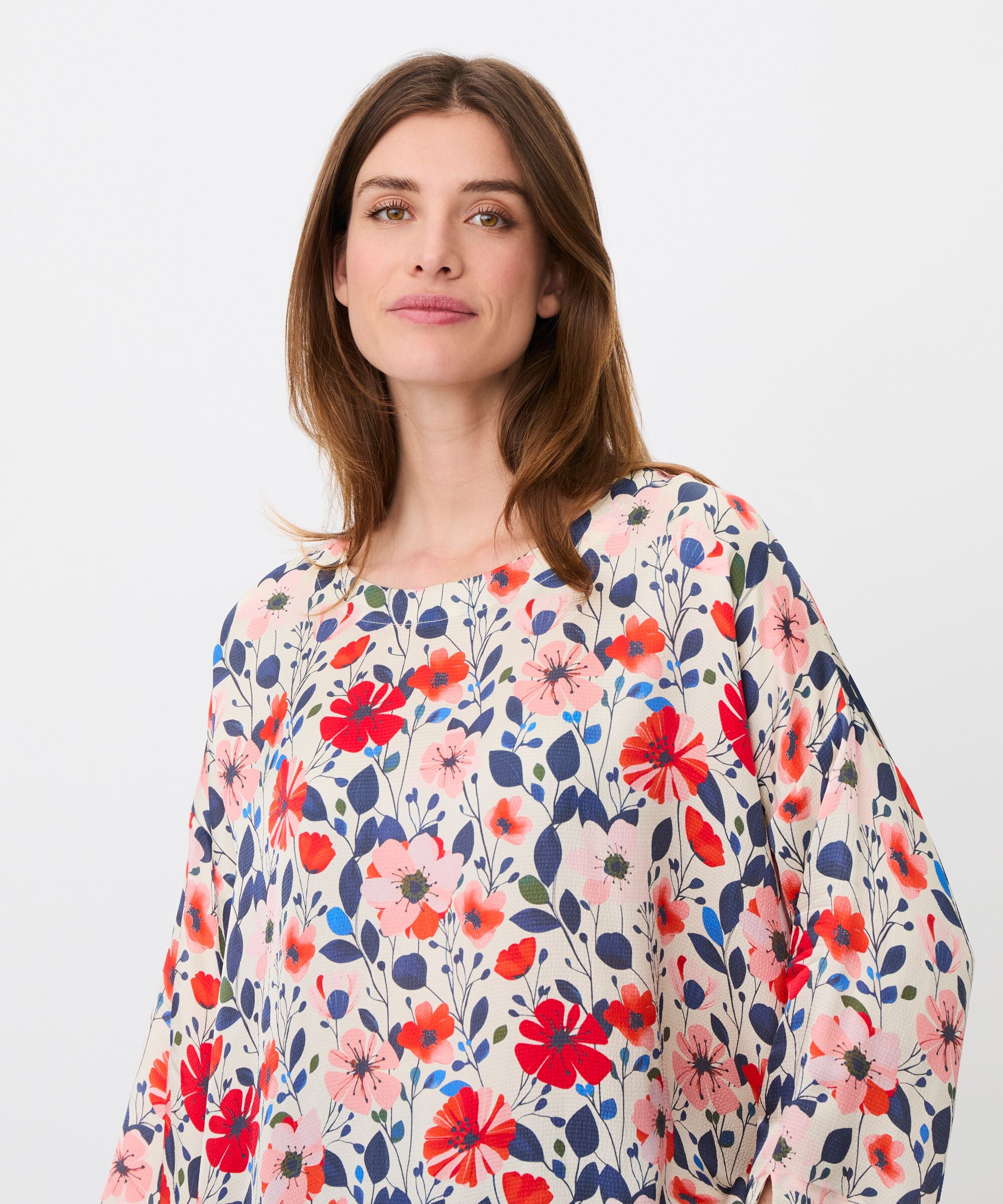 Woman wearing a floral blouse with a white background