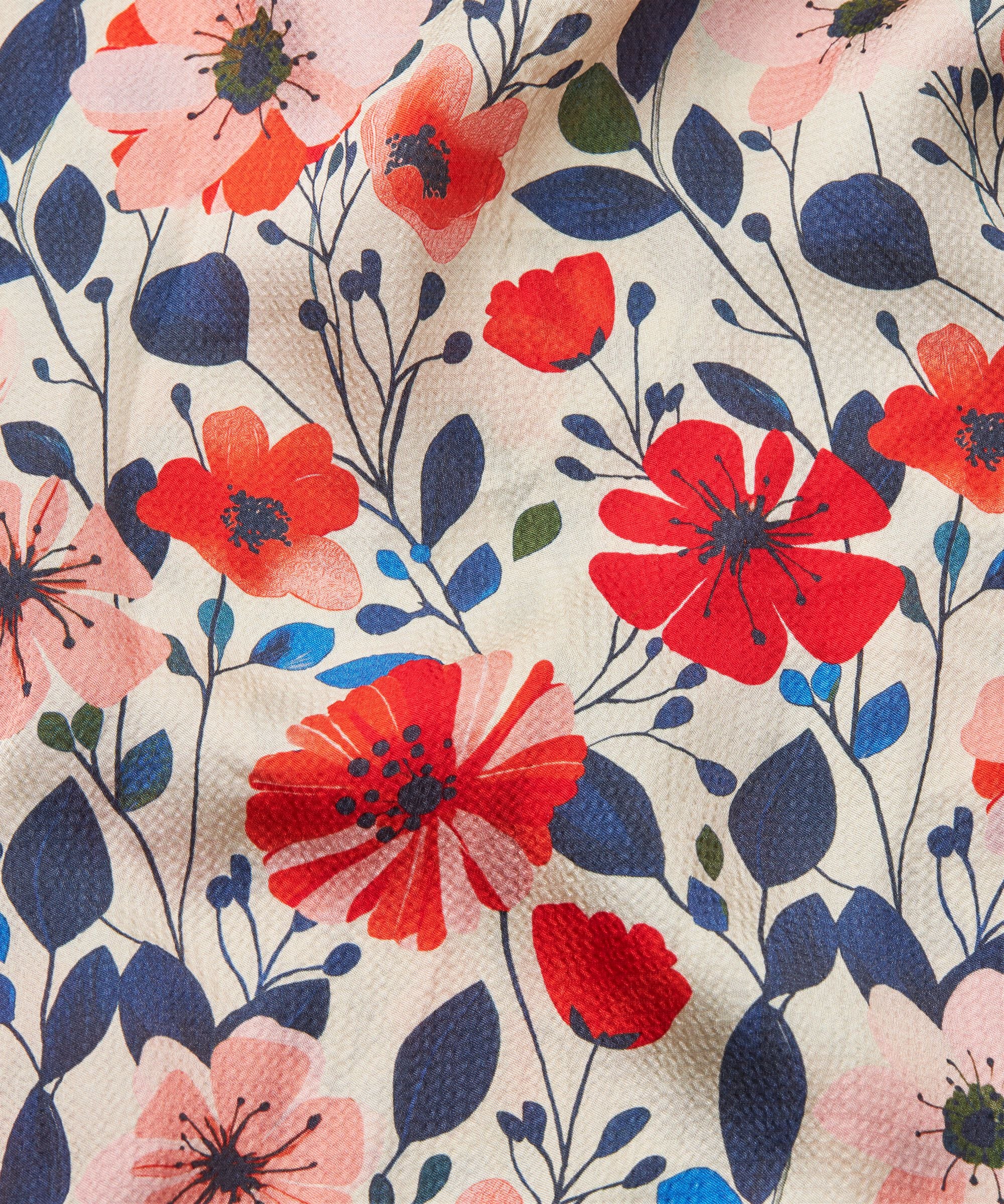 Floral pattern with red, pink, and blue flowers on a beige background