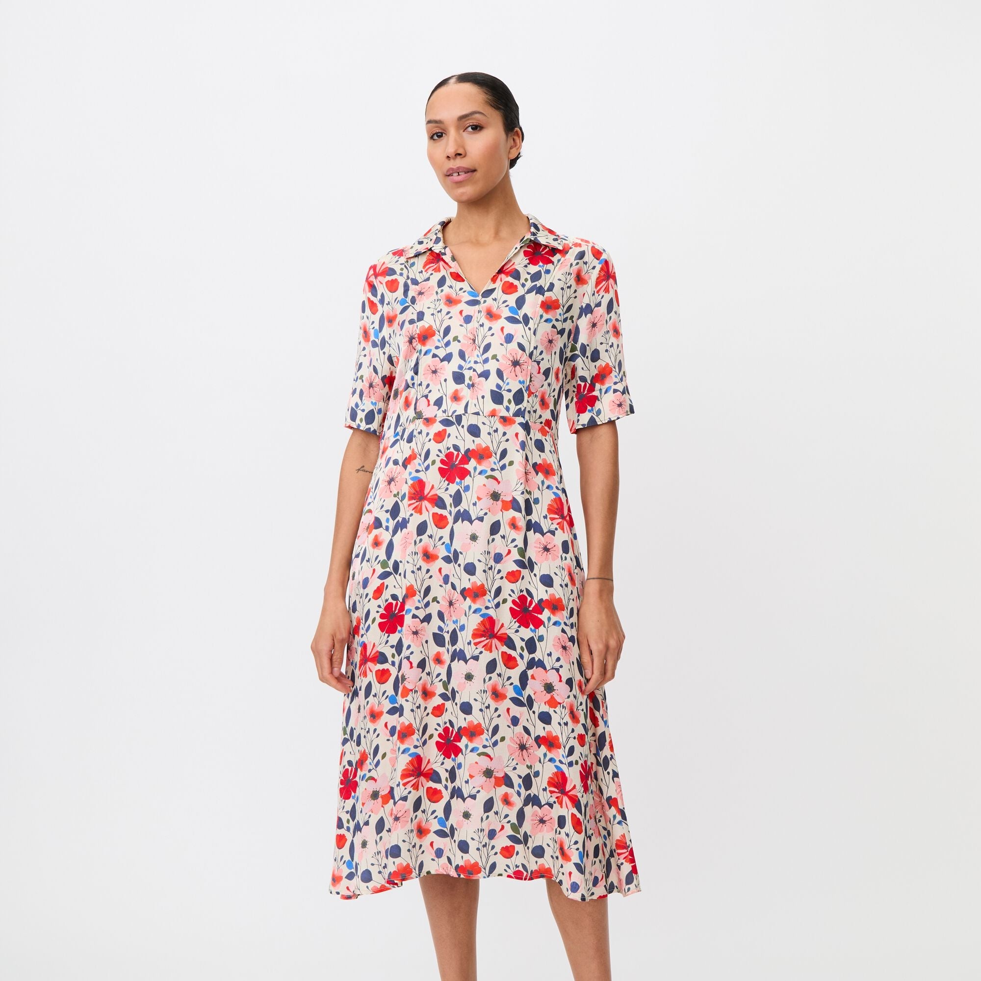 Woman wearing a floral dress on a white background