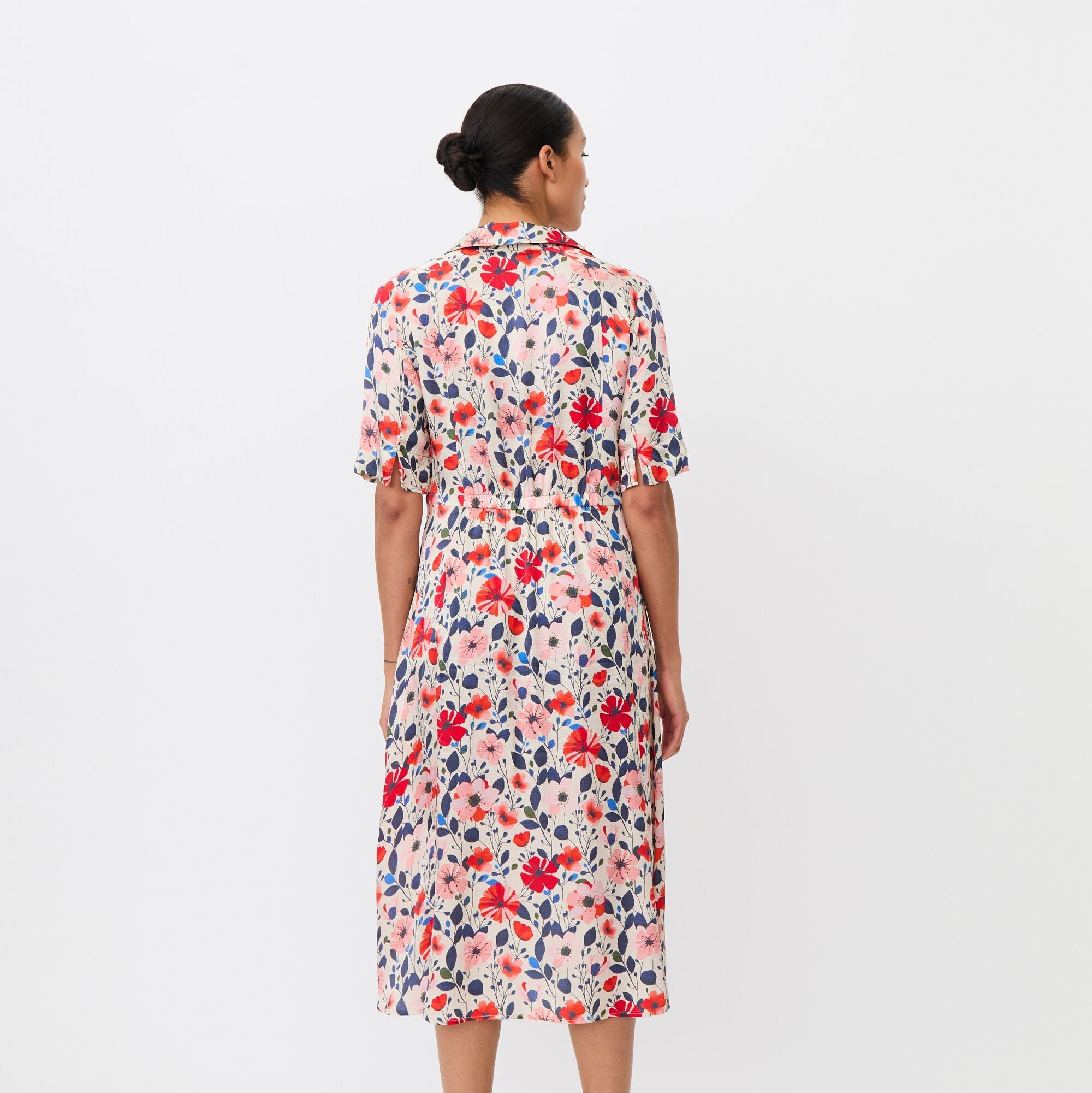 Woman wearing a floral dress on a white background