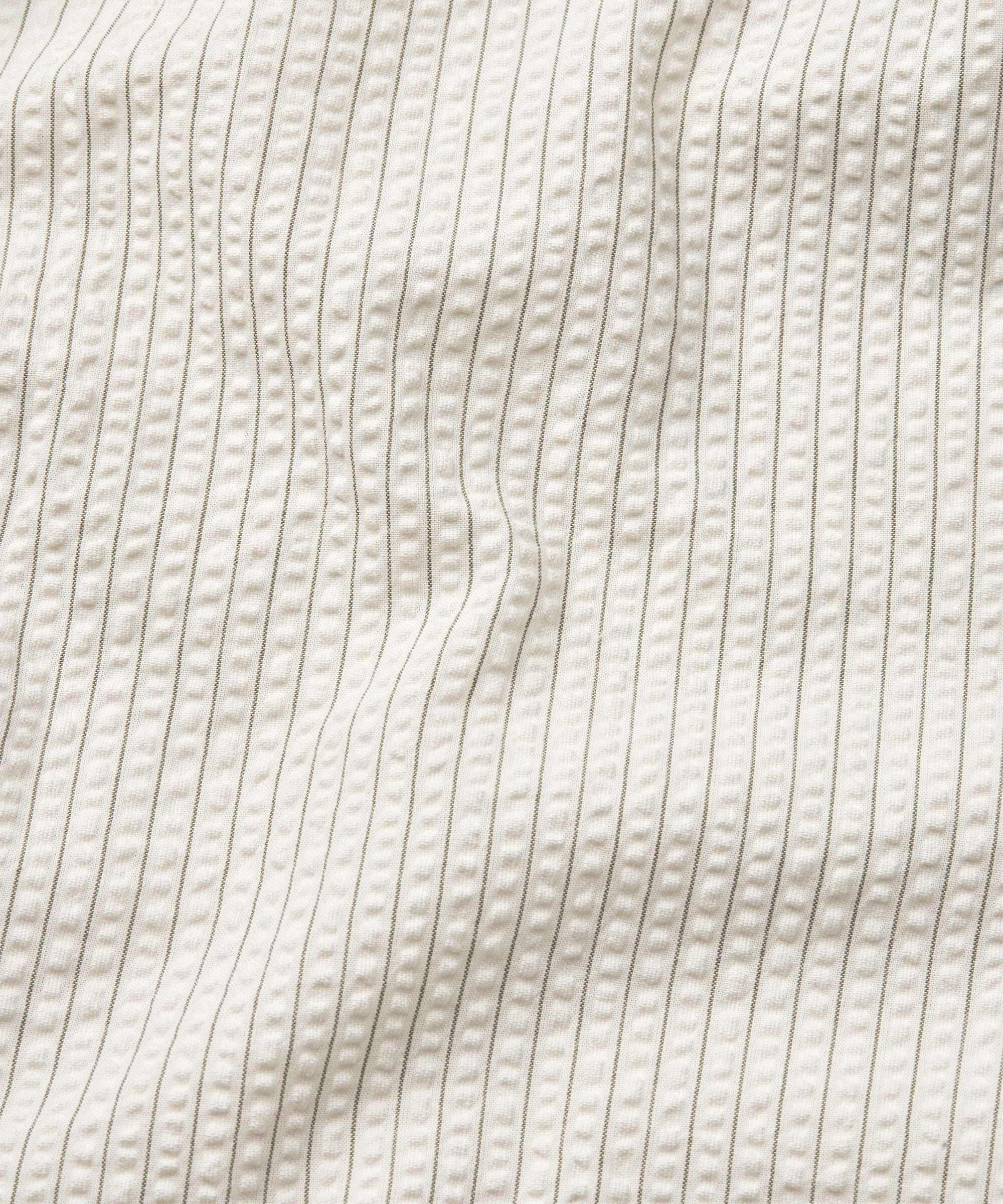 Close-up of textured beige fabric with wavy pattern