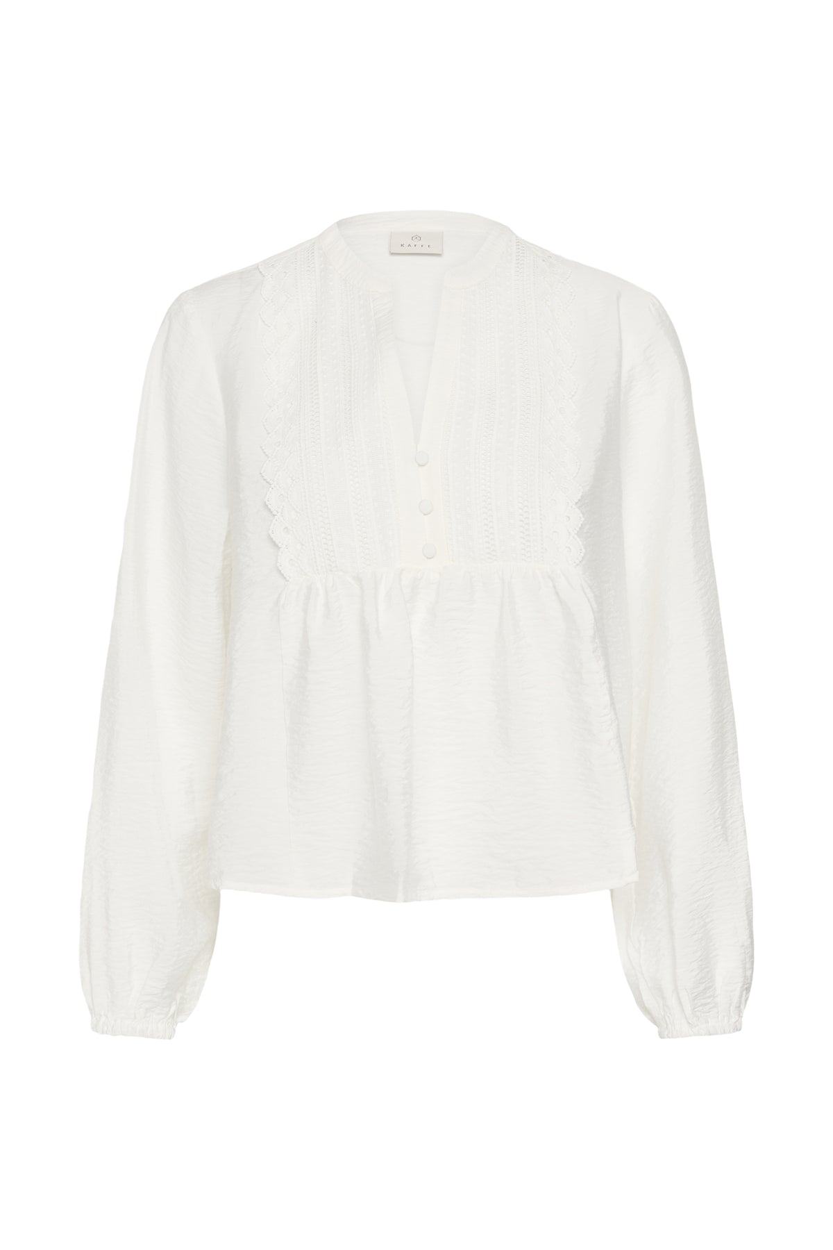 A white long-sleeve blouse with a gathered peplum waist, buttoned front, and delicate lace-up detail at the collar, shown against a plain white background.