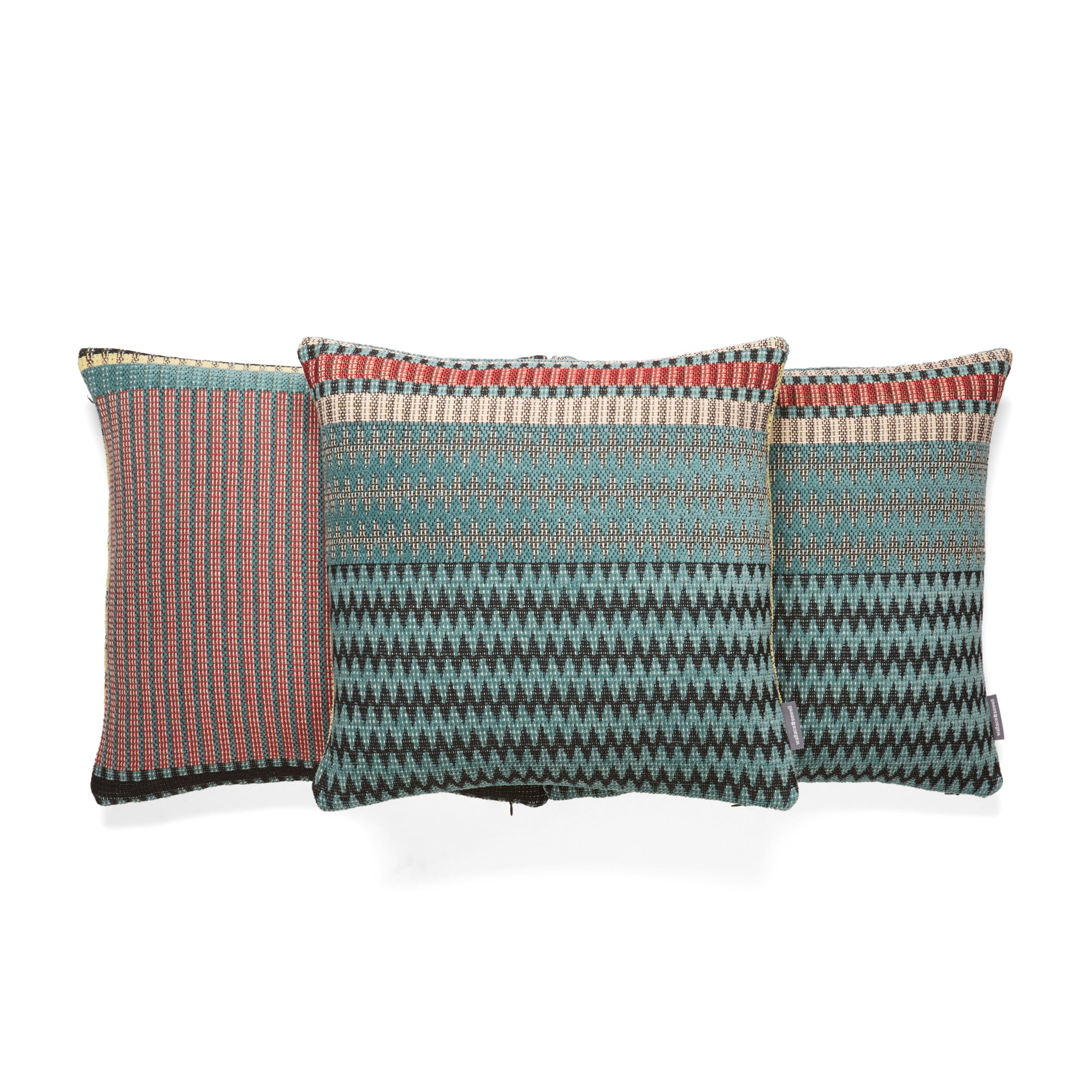 Three rectangular throw pillows with teal, red, and black geometric patterns.