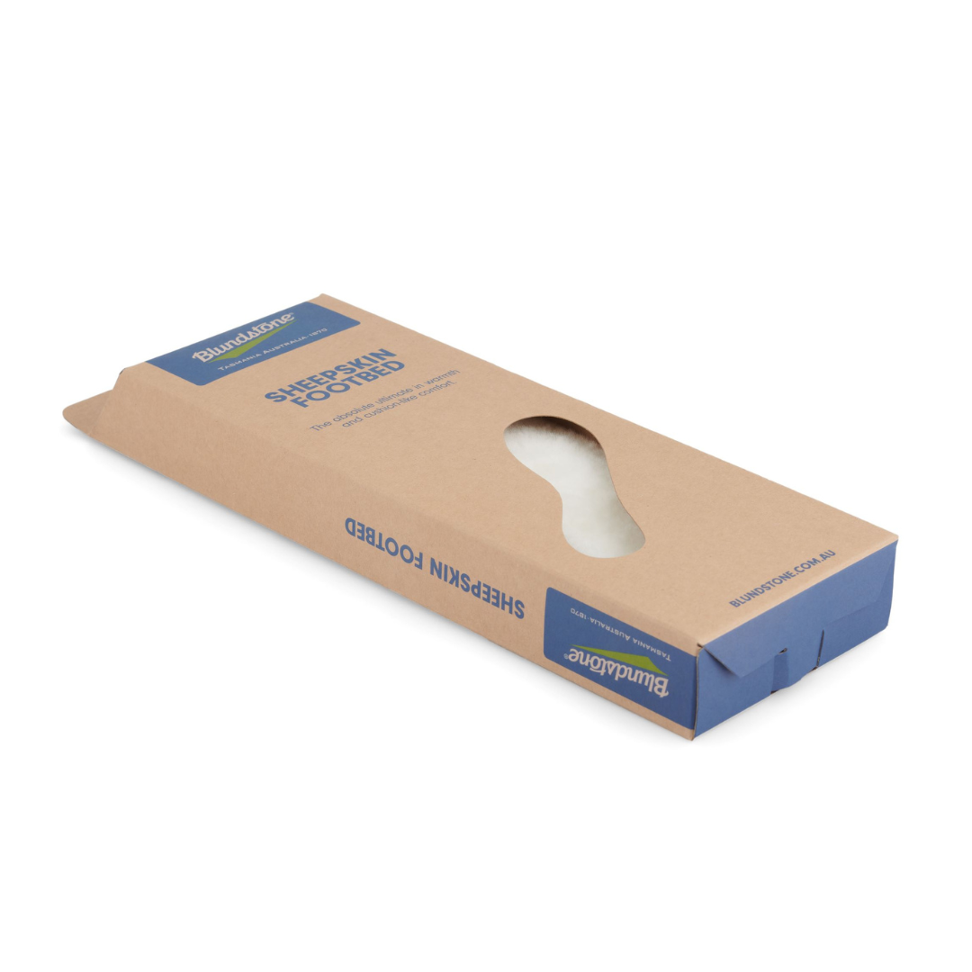 Blundstone sheepskin footbed in a brown cardboard box with a cutout showing the white sheepskin insole.