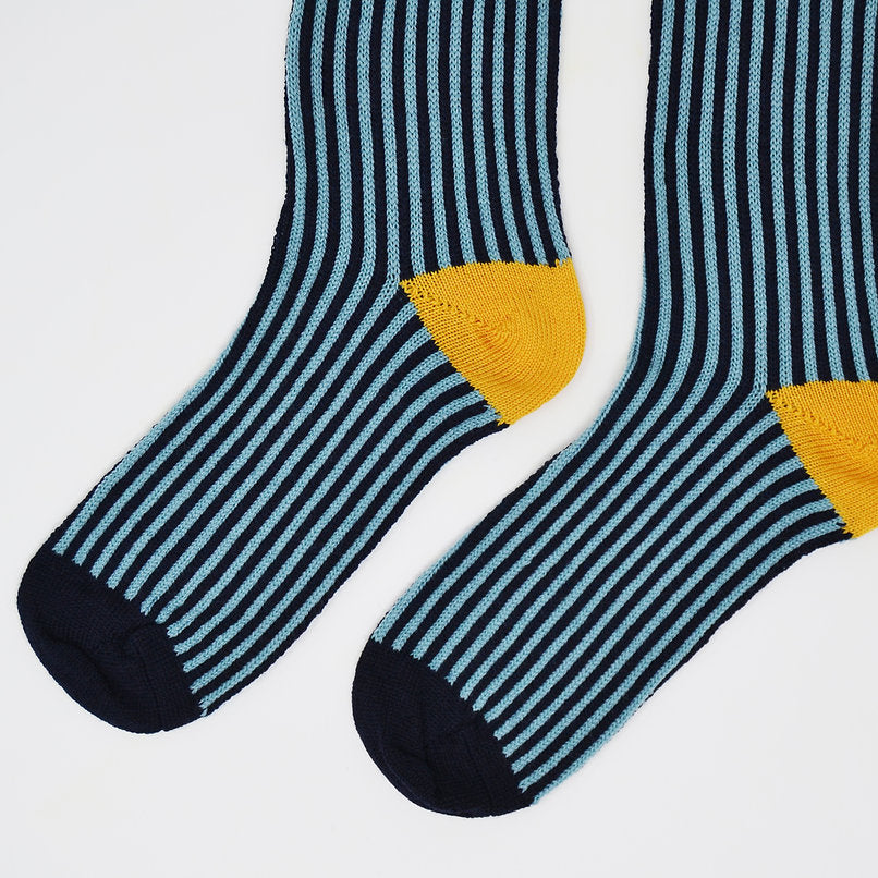 Pair of striped socks in teal and navy blue with mustard yellow heel and toe.