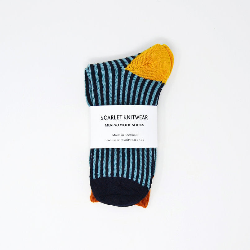 Pair of teal and navy striped merino wool socks with yellow and orange heel and toe details.
