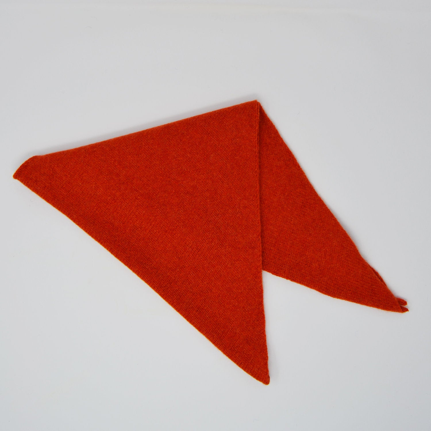 Red fabric triangle on a light gray background