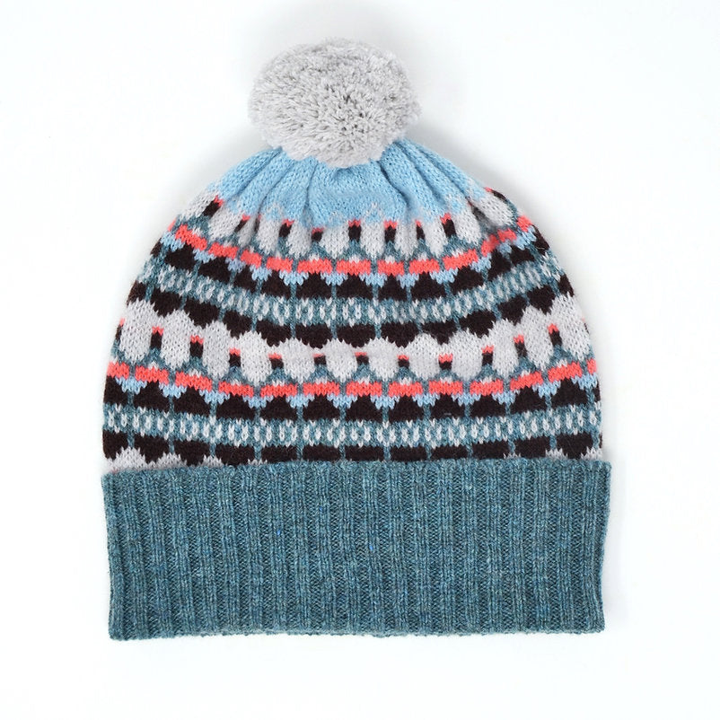Fair isle knit beanie with pompom, teal and light blue body, dark brown and coral pattern.
