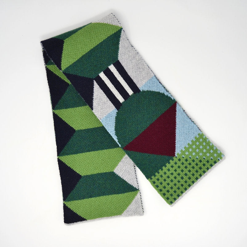 Geometric patterned knit scarf in greens, blues, and burgundy.