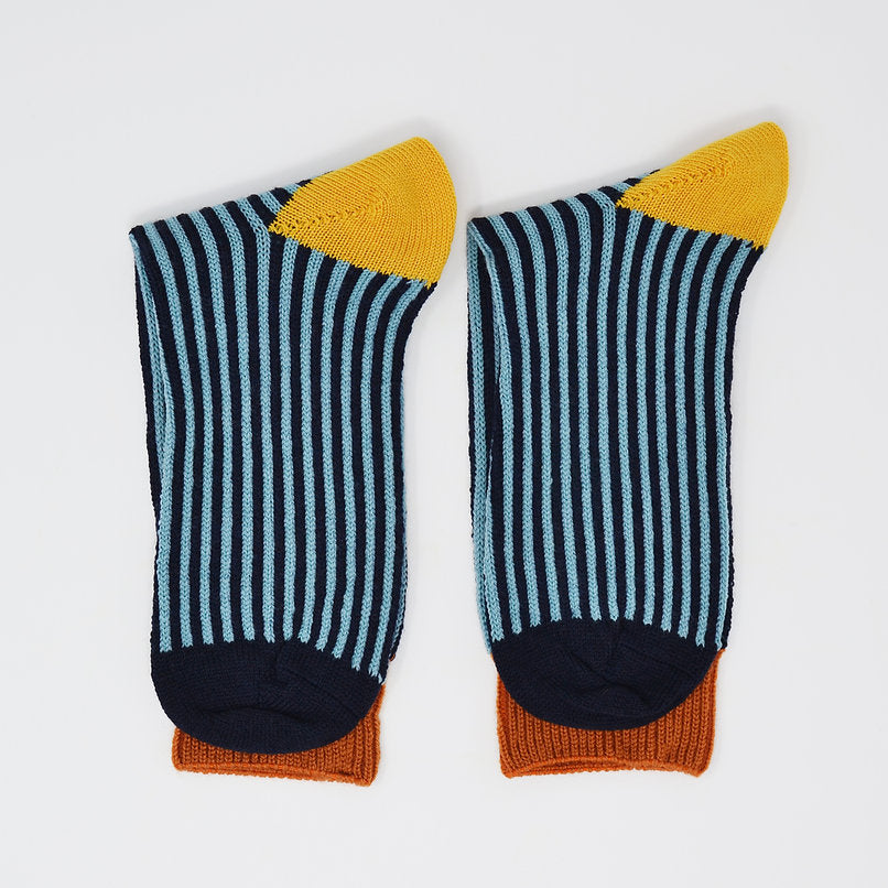 Pair of striped socks in teal and navy blue, with mustard yellow and burnt orange accents at the top and cuff.