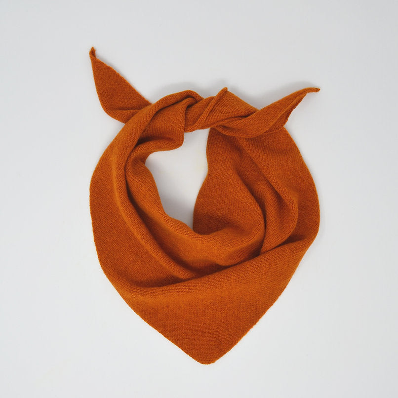 Burnt orange knitted triangular scarf.