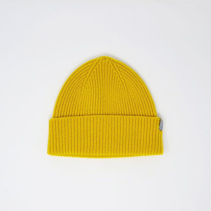 Mustard yellow ribbed knit beanie.