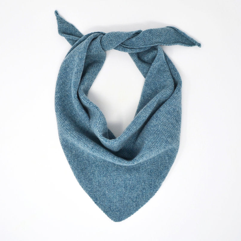 A teal blue knitted wool bandana, folded and tied.