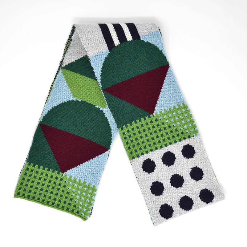 Geometric patterned knit scarf in greens, burgundy, and light blue.  Features circles, triangles, and polka dots.