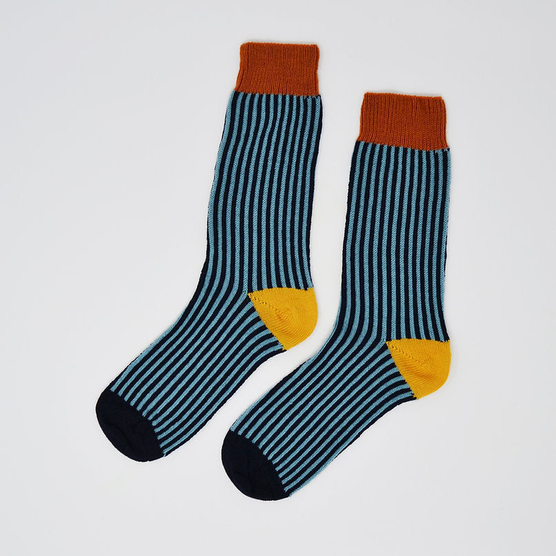 Pair of teal and navy striped socks with orange cuffs and yellow heels.