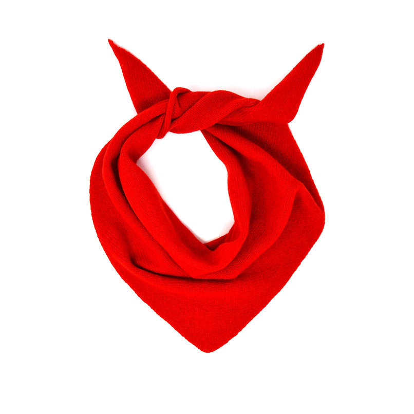 Red knitted triangular scarf, loosely knotted.