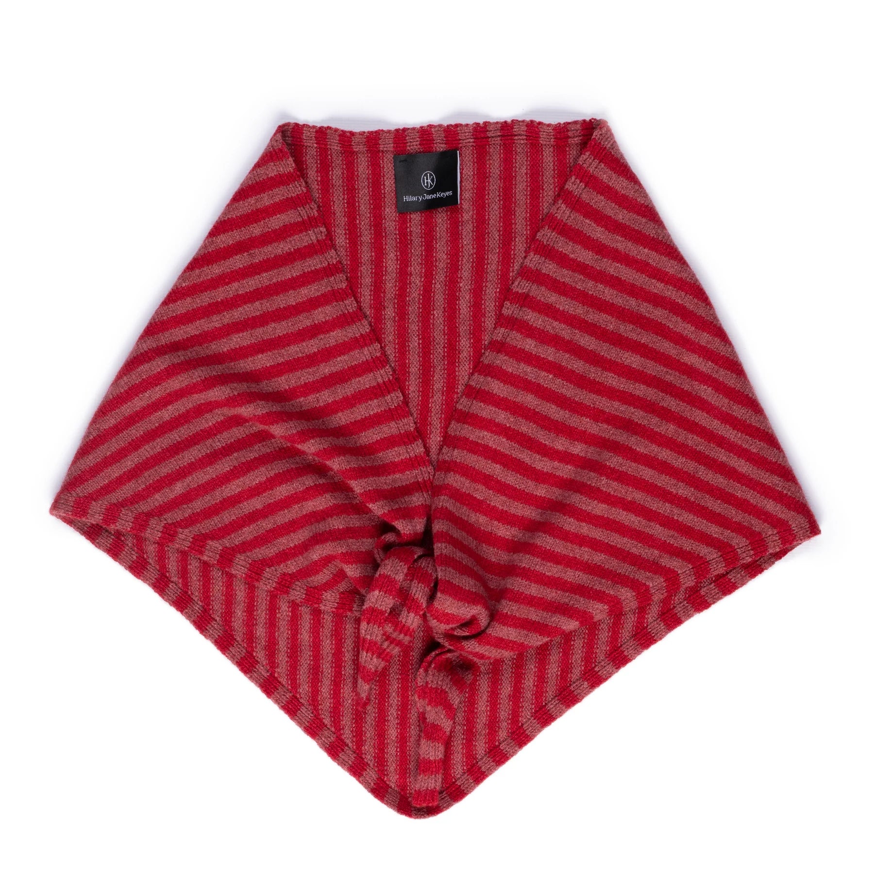 A red and pink striped knit wrap or shawl with a V-neck and tie closure, laid flat on a white background.