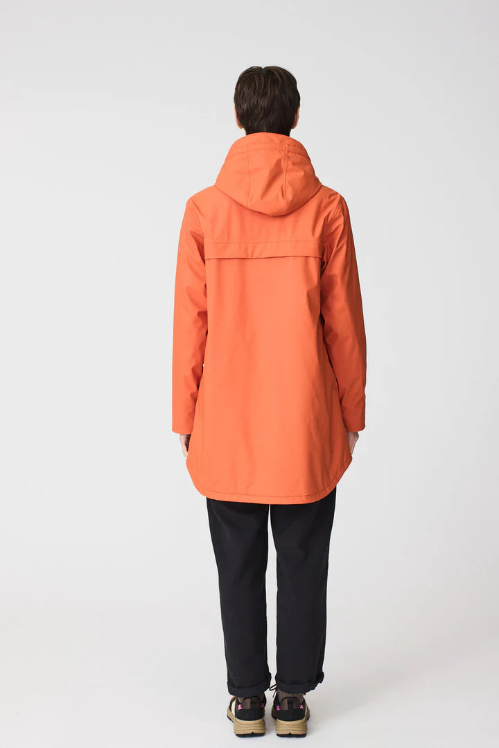 Person wearing an orange raincoat on a white background