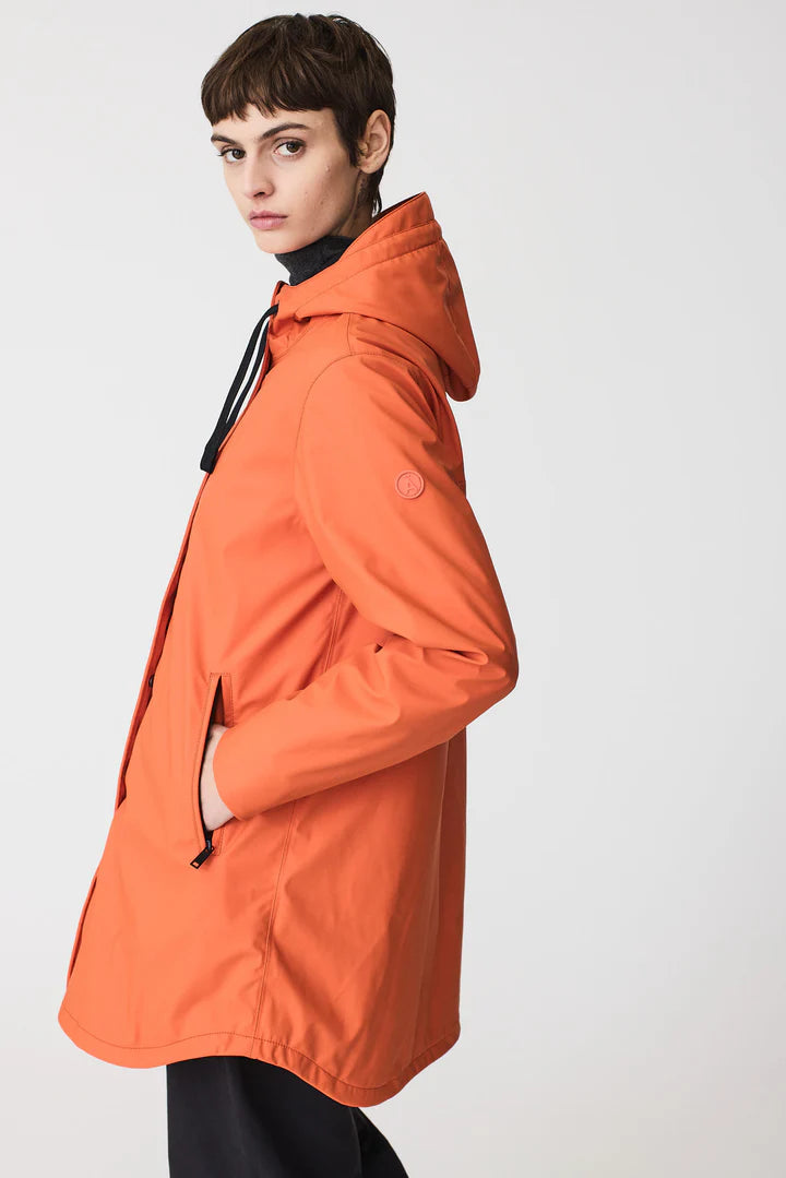 Person wearing an orange raincoat on a white background