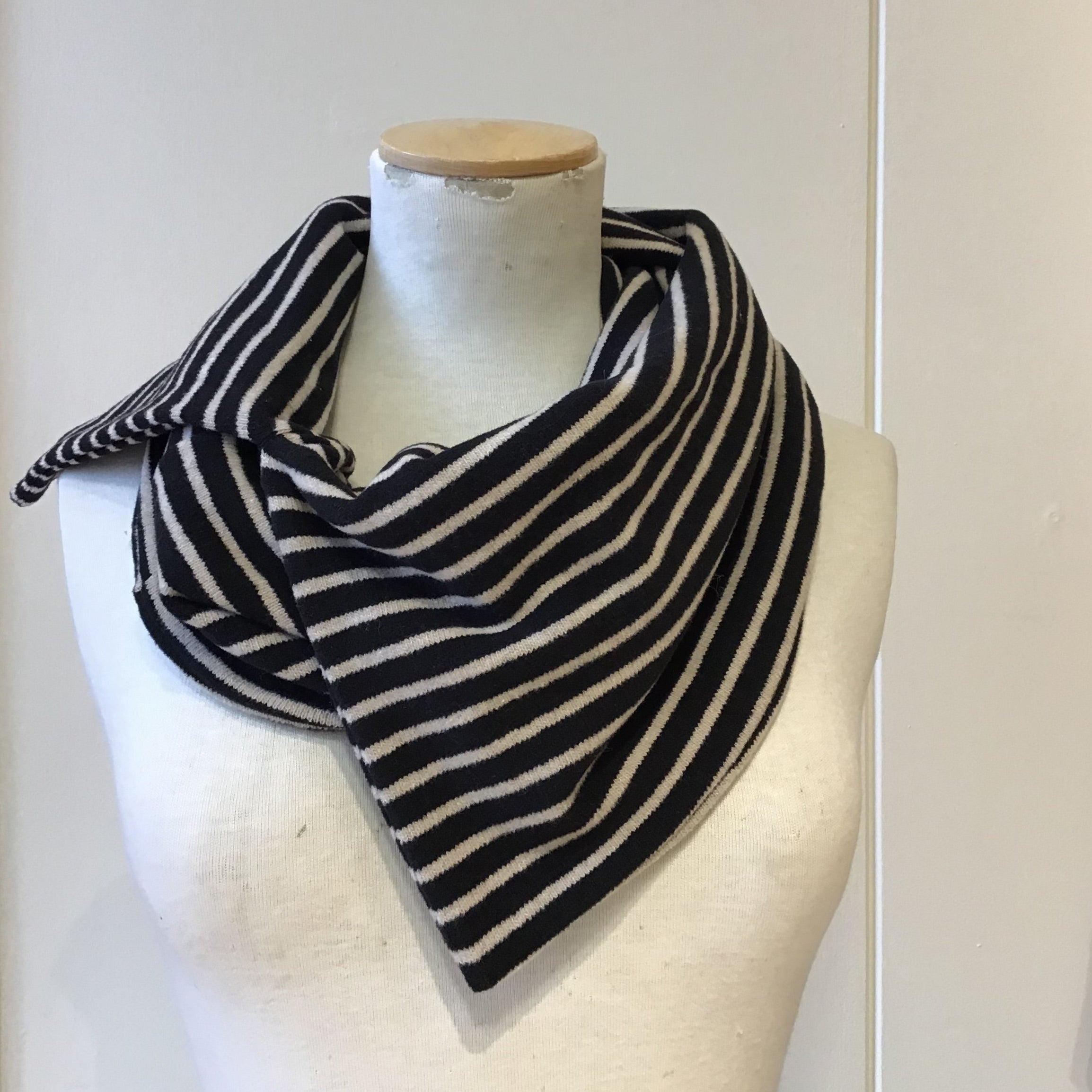 Black and cream horizontally striped cowl neck scarf.
