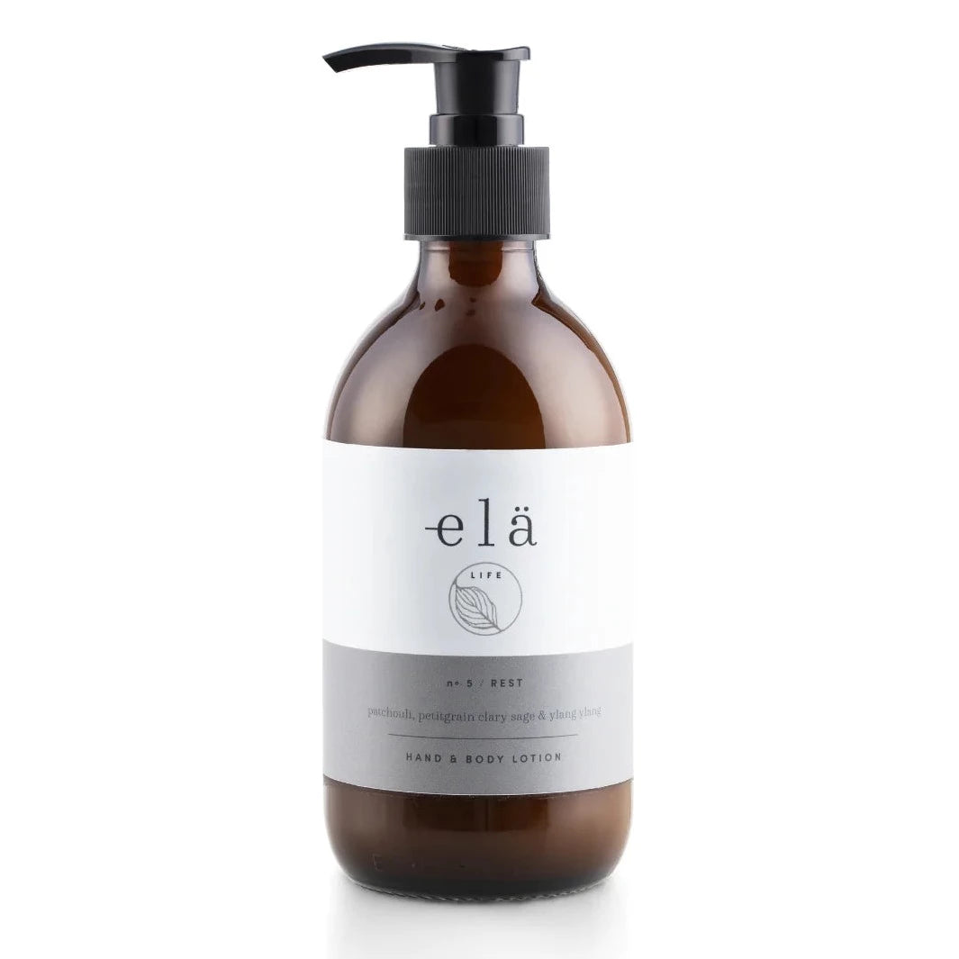Amber glass bottle of elā Life hand & body lotion with a black pump top.  Label indicates "No.