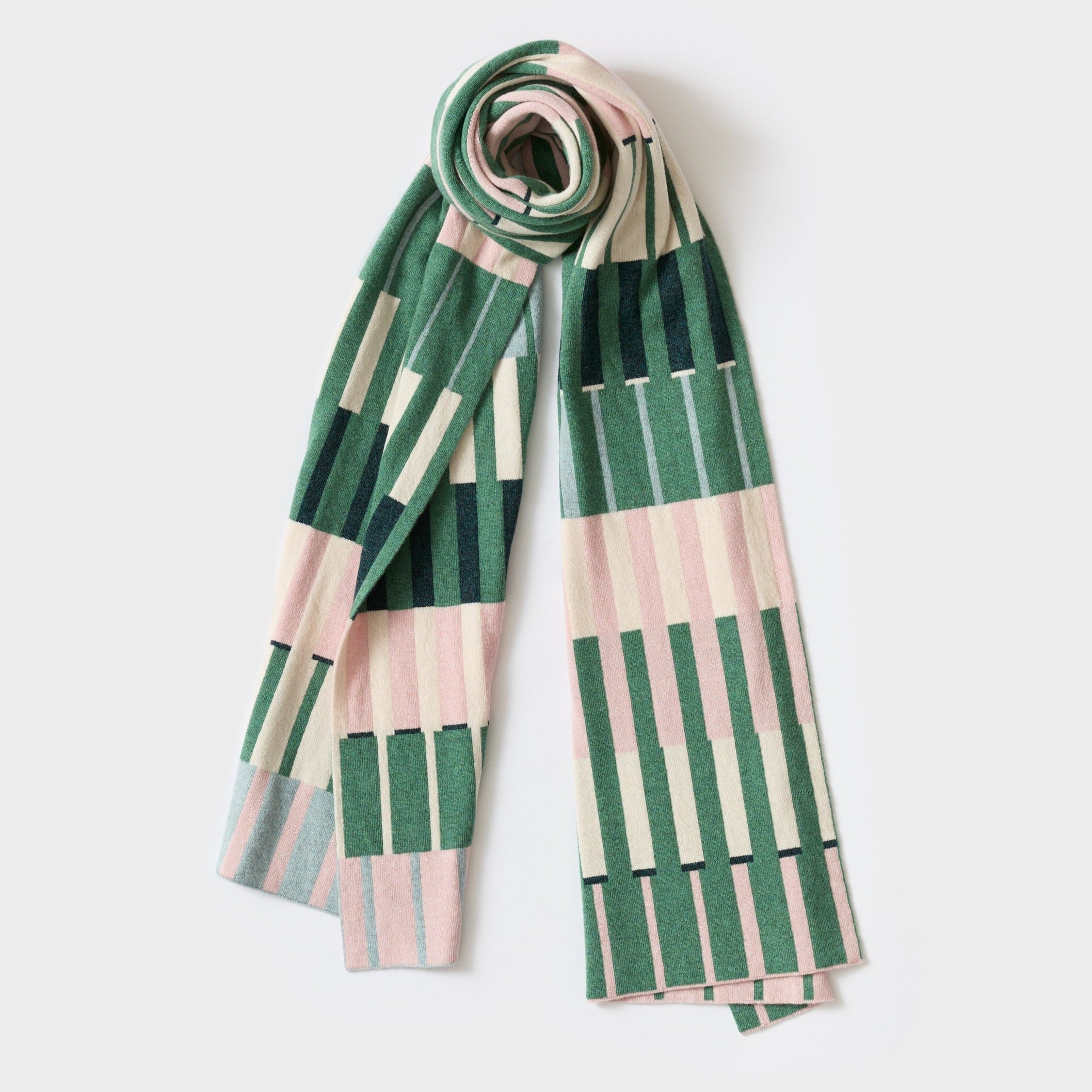 Knit scarf with a geometric pattern in shades of green, pink, and cream.