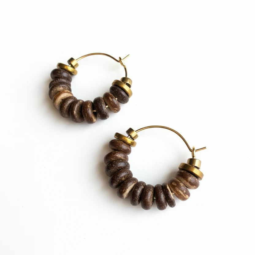 Pair of hoop earrings with brown beads and gold accents on a white background
