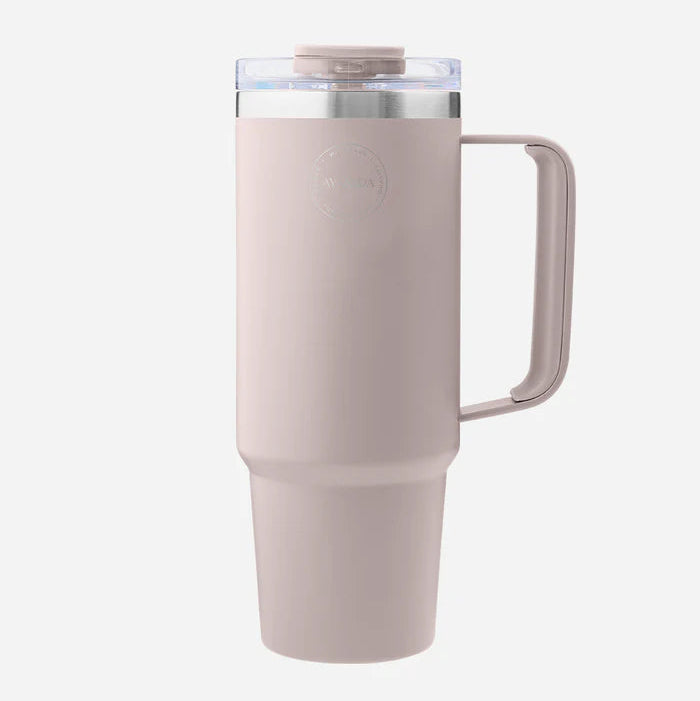 Pink insulated tumbler with handle on a white background