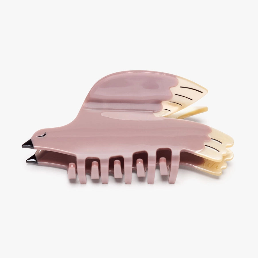 Pink bird-shaped hair clip on a white background