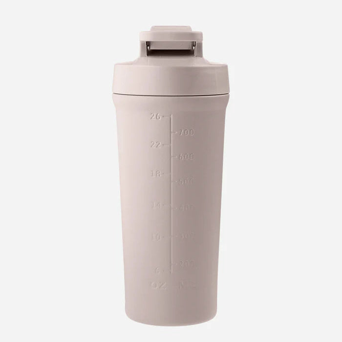 Beige tumbler with measurement markings on a white background