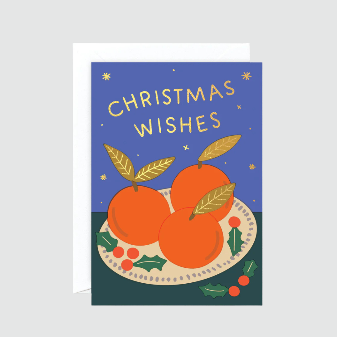 Christmas card with oranges and holly on a blue background